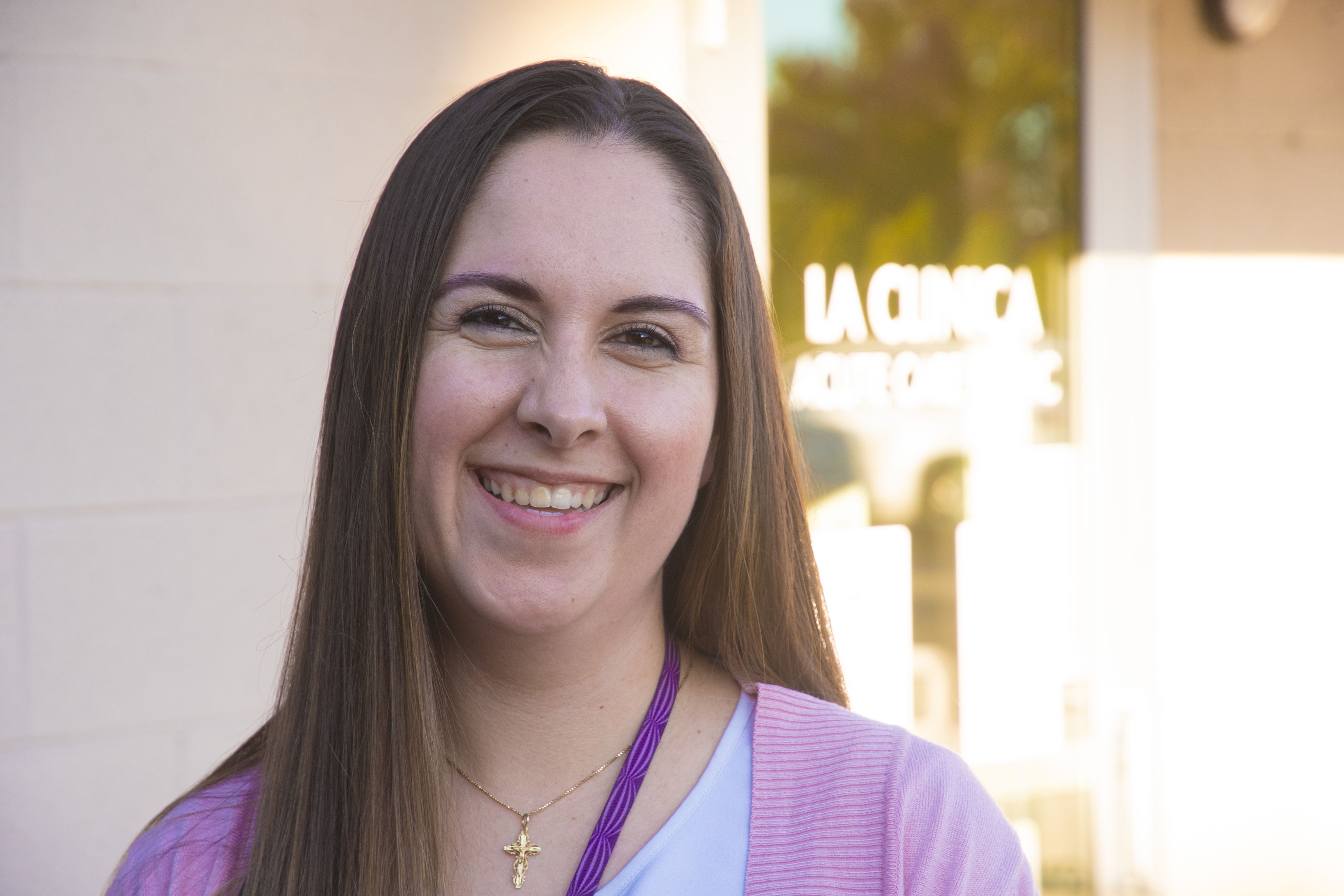 Photo of woman standing in front of La Clinica sign.
